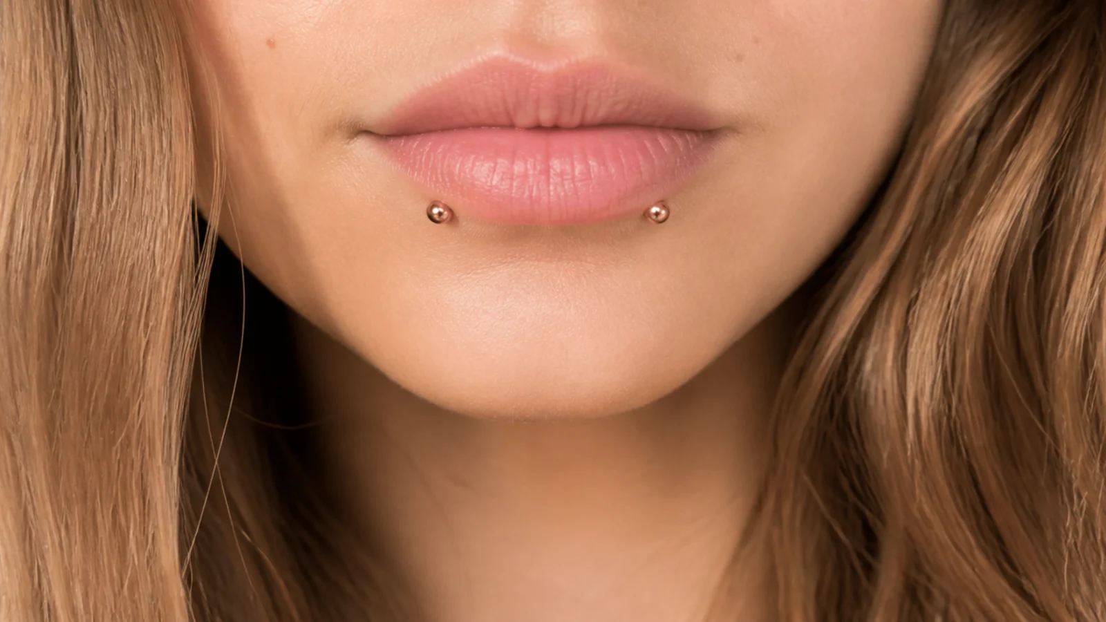 Tiny rose gold studs on angel fangs for small lips
