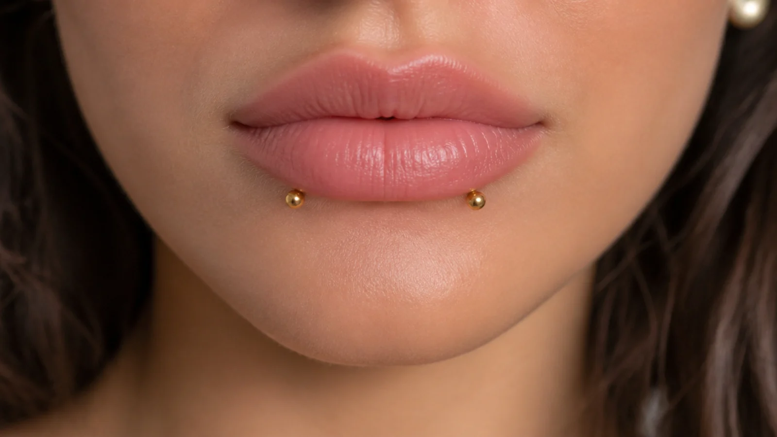 Tiny high-shine gold studs on angel fangs for small lips