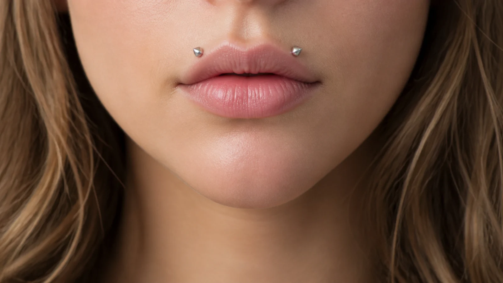 A clear view of inverted angel fangs placement on the upper lip