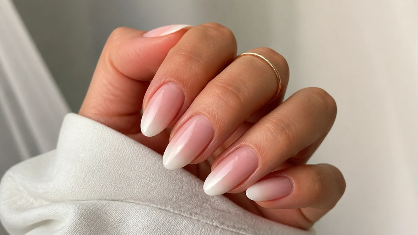 Classic almond baby boomer nails with a glossy finish