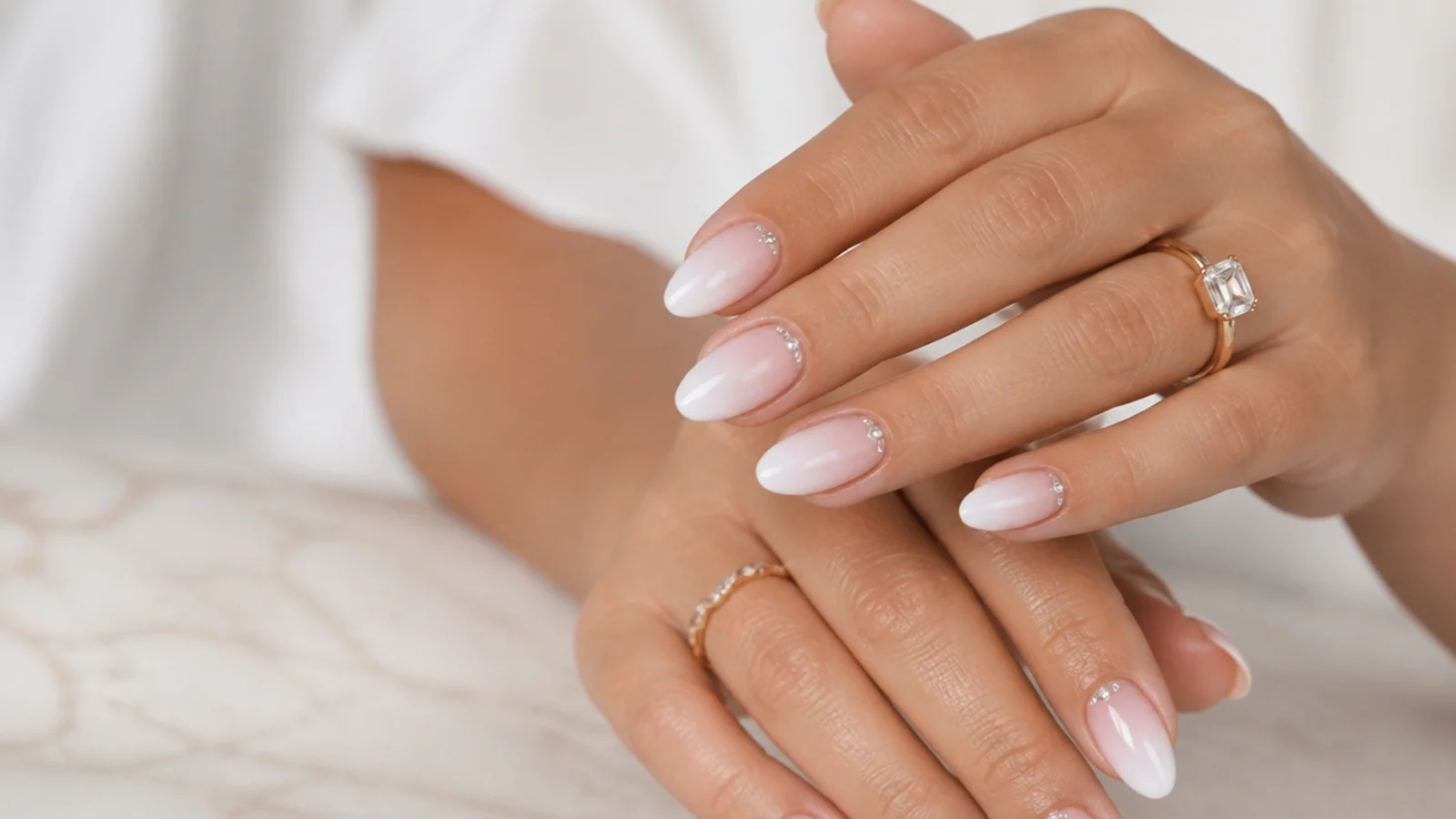 Almond baby boomer nails with rhinestone accents