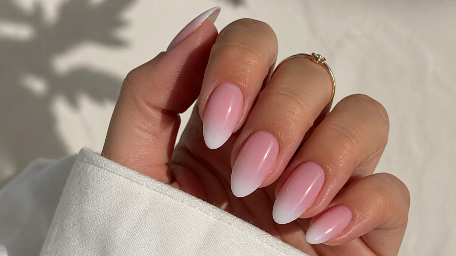 Classic pink-to-white baby boomer nails in an almond shape