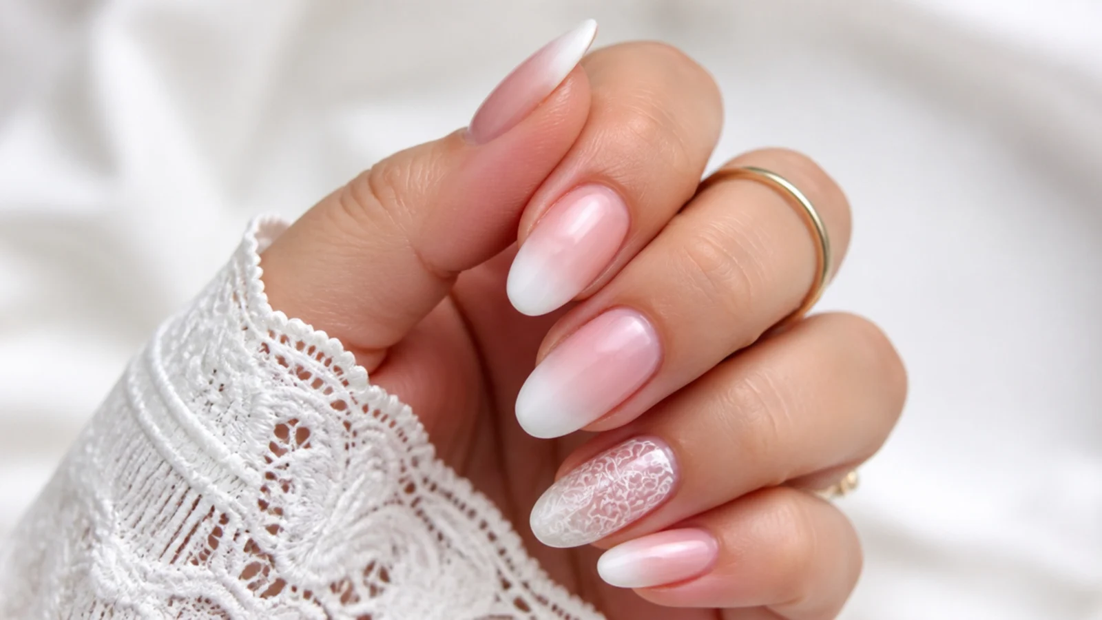 Baby boomer nails with a delicate lace-detail accent