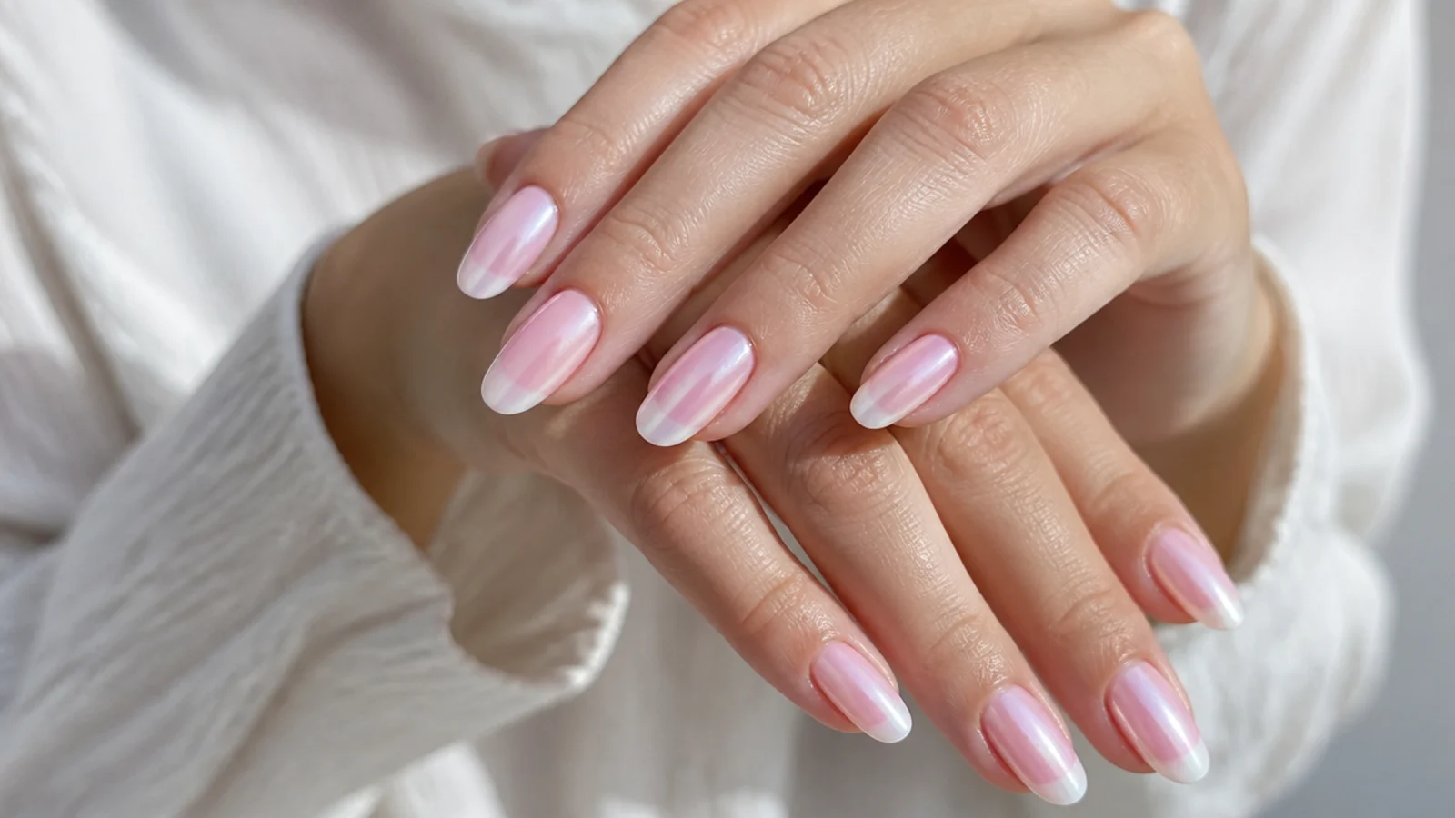 Baby boomer nails with a pink aurora chrome