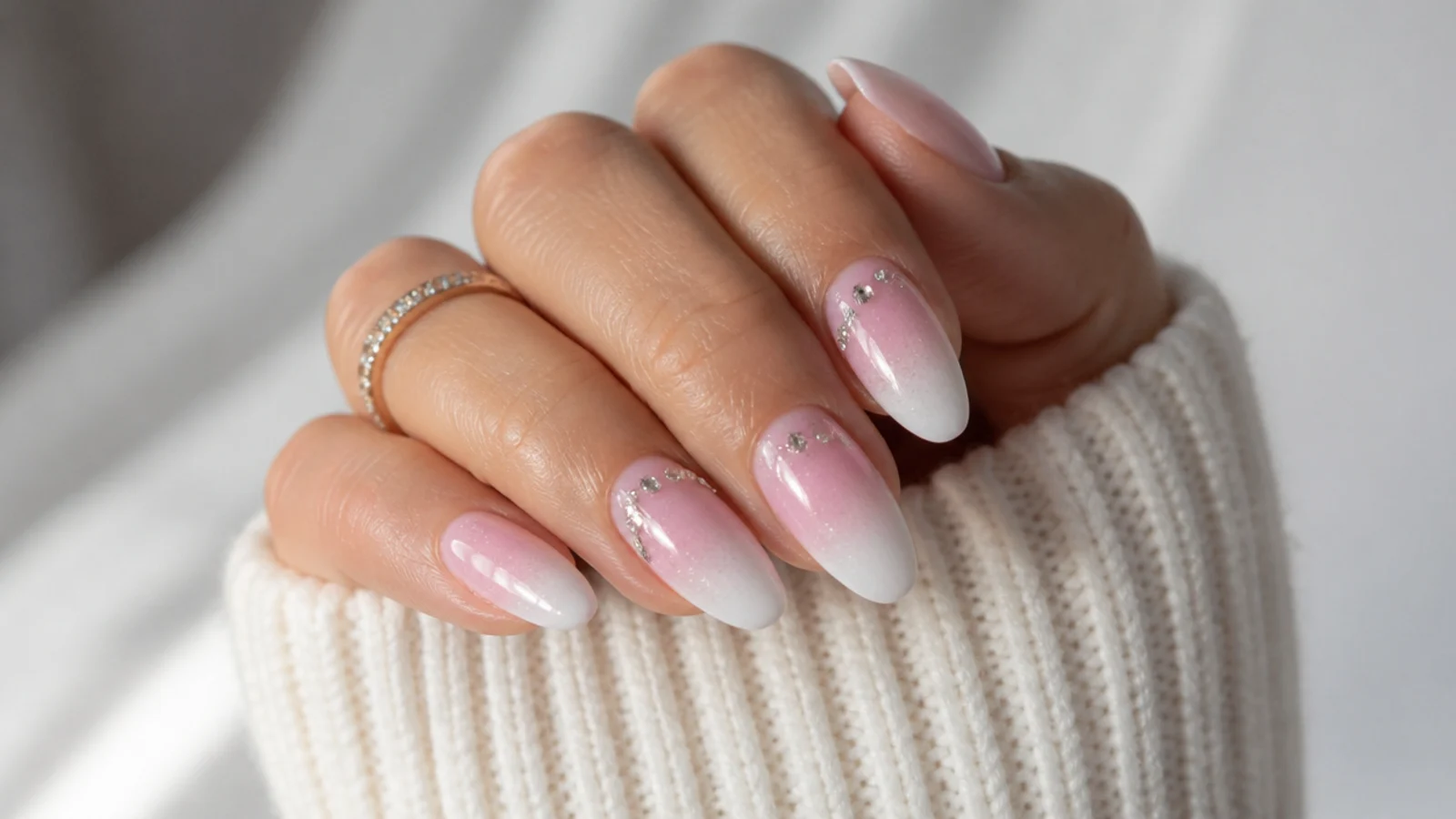 Baby boomer nails with glitter and a few rhinestones