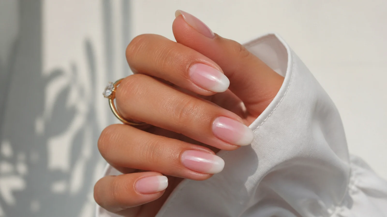 Pink baby boomer nails with a pearl shimmer