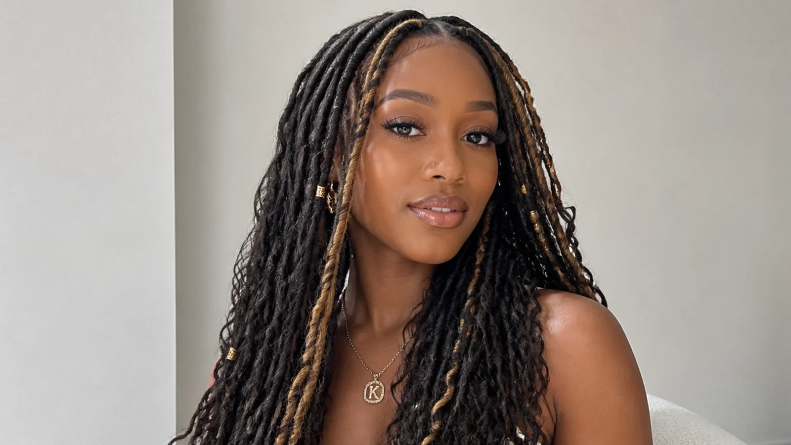Dark butterfly locs with blonde face-framing pieces