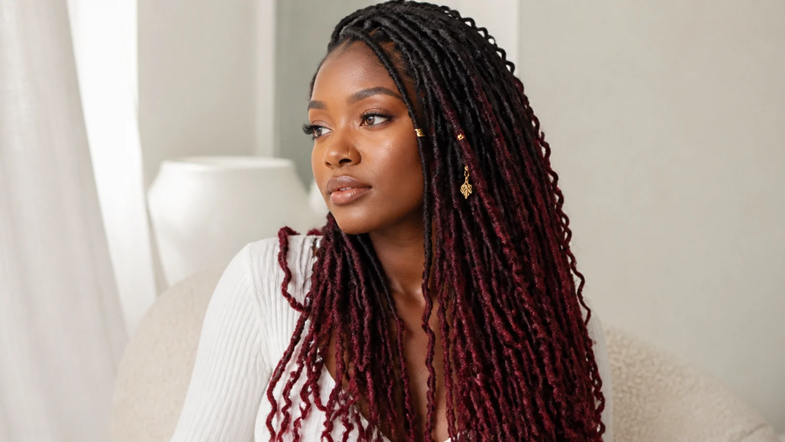 Butterfly locs fading from black roots to burgundy ends