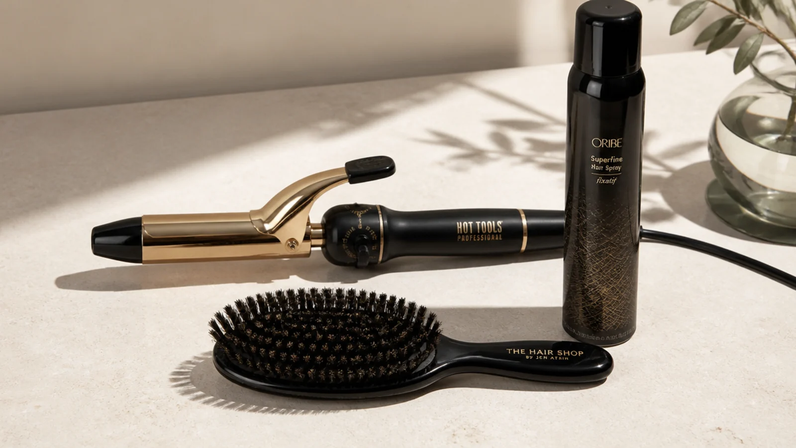 A curling iron, boar-bristle brush and shine spray for Hollywood waves