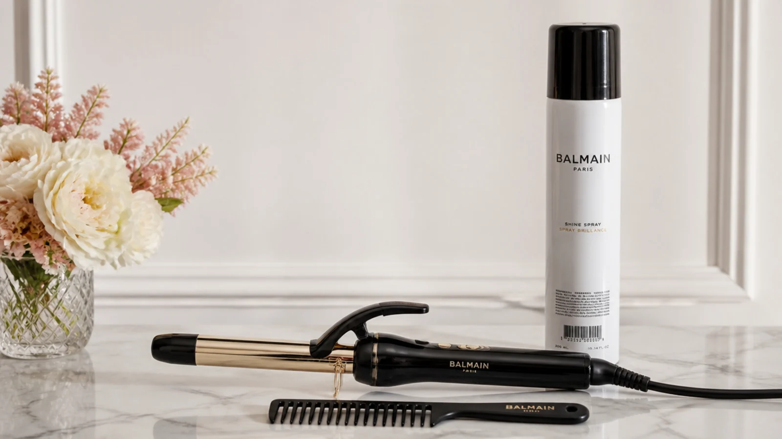 A curling iron, comb and shine spray for middle-part glam waves