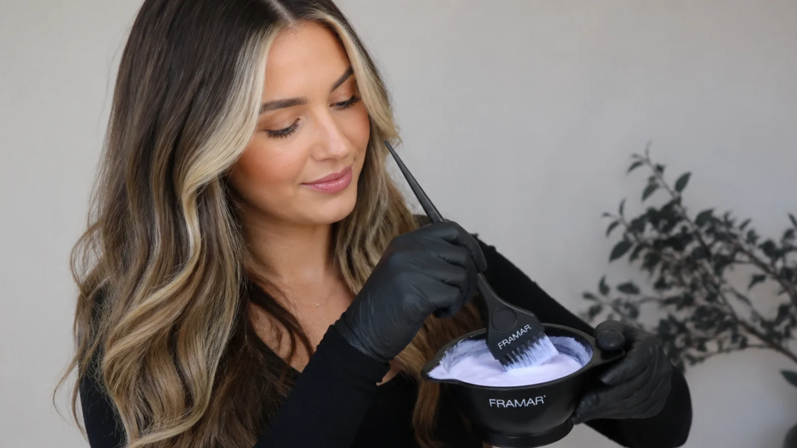 Mixing hair lightener and developer in a bowl with a tint brush