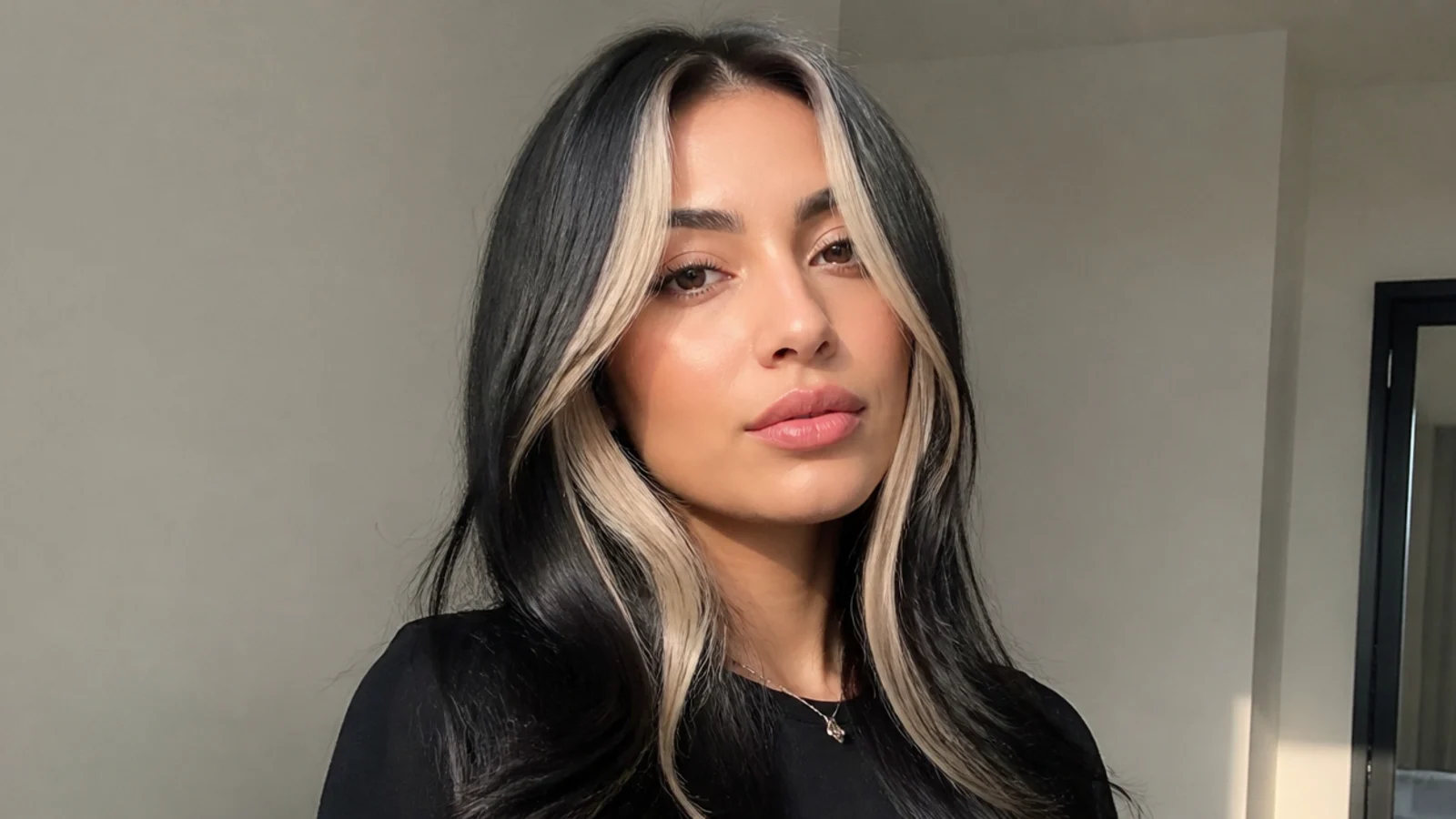 Black hair with a bold bright blonde money piece