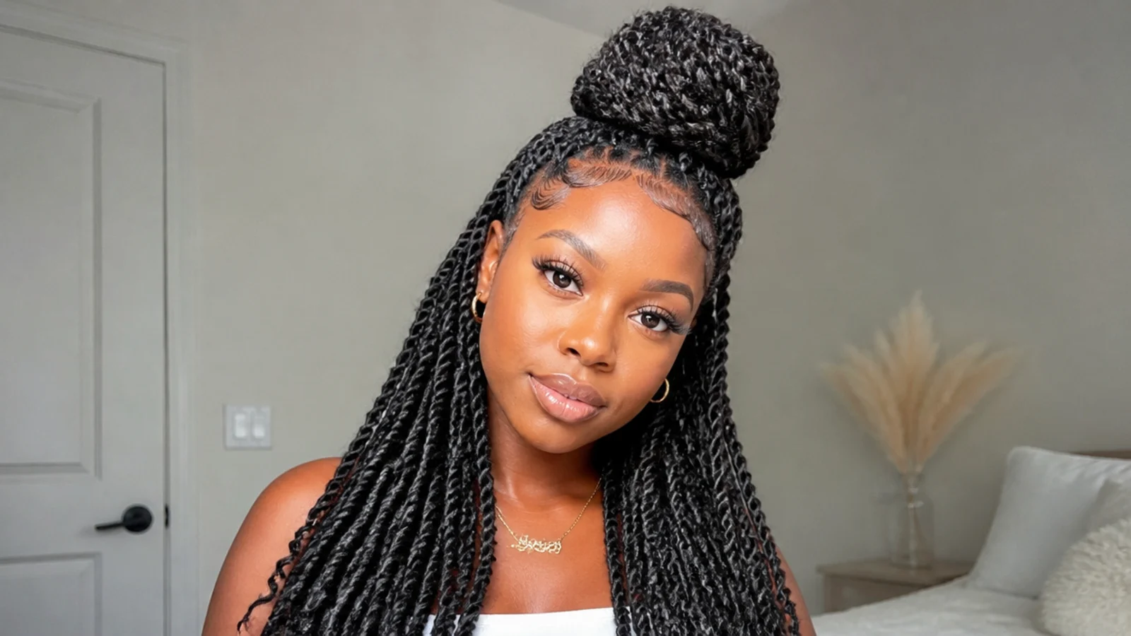 Passion twists styled in a half-up bun