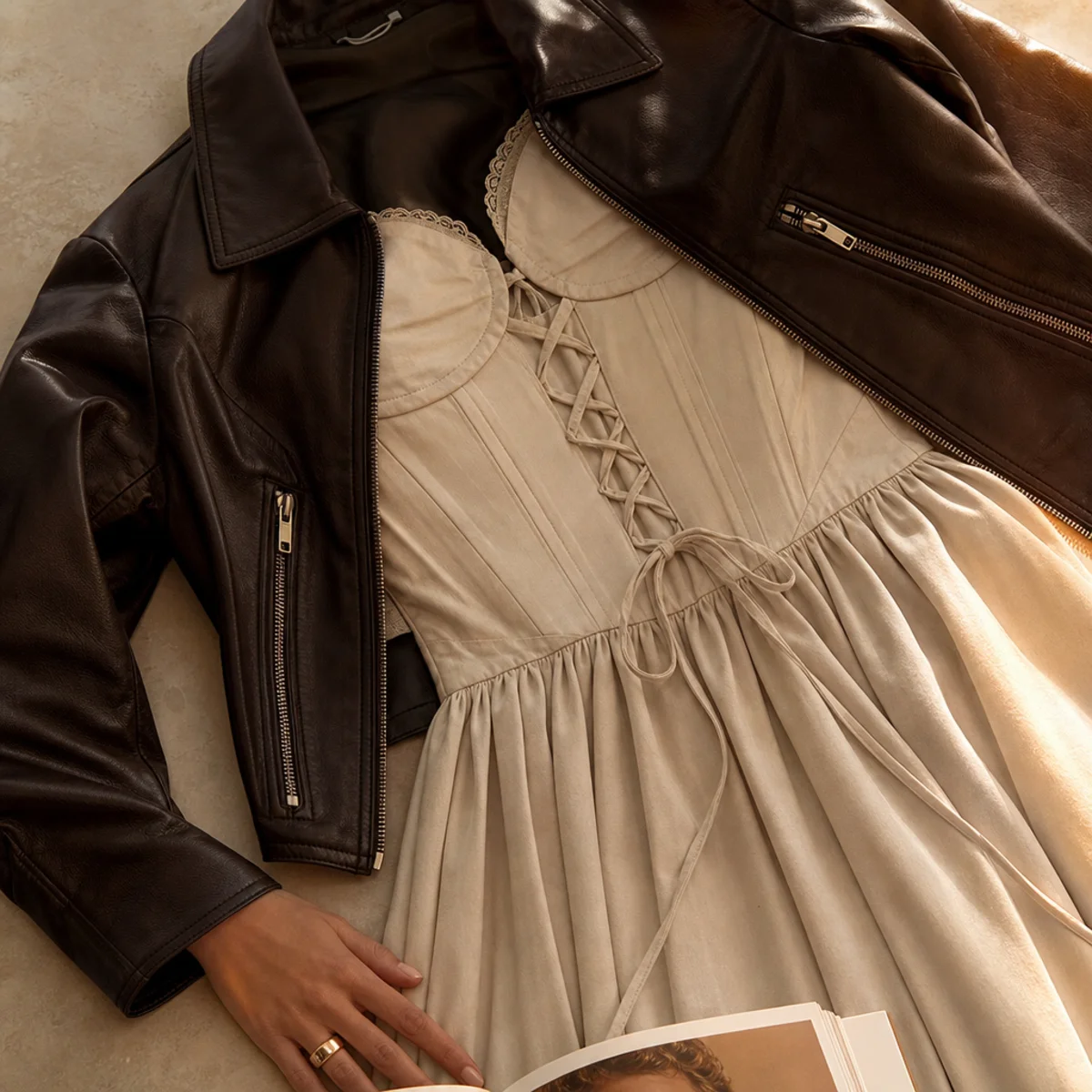 Faceless full-length shot of a corset dress with a leather jacket and boots