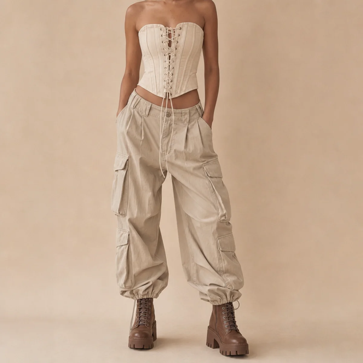 Faceless full-length shot of a corset top with baggy cargo pants and chunky boots