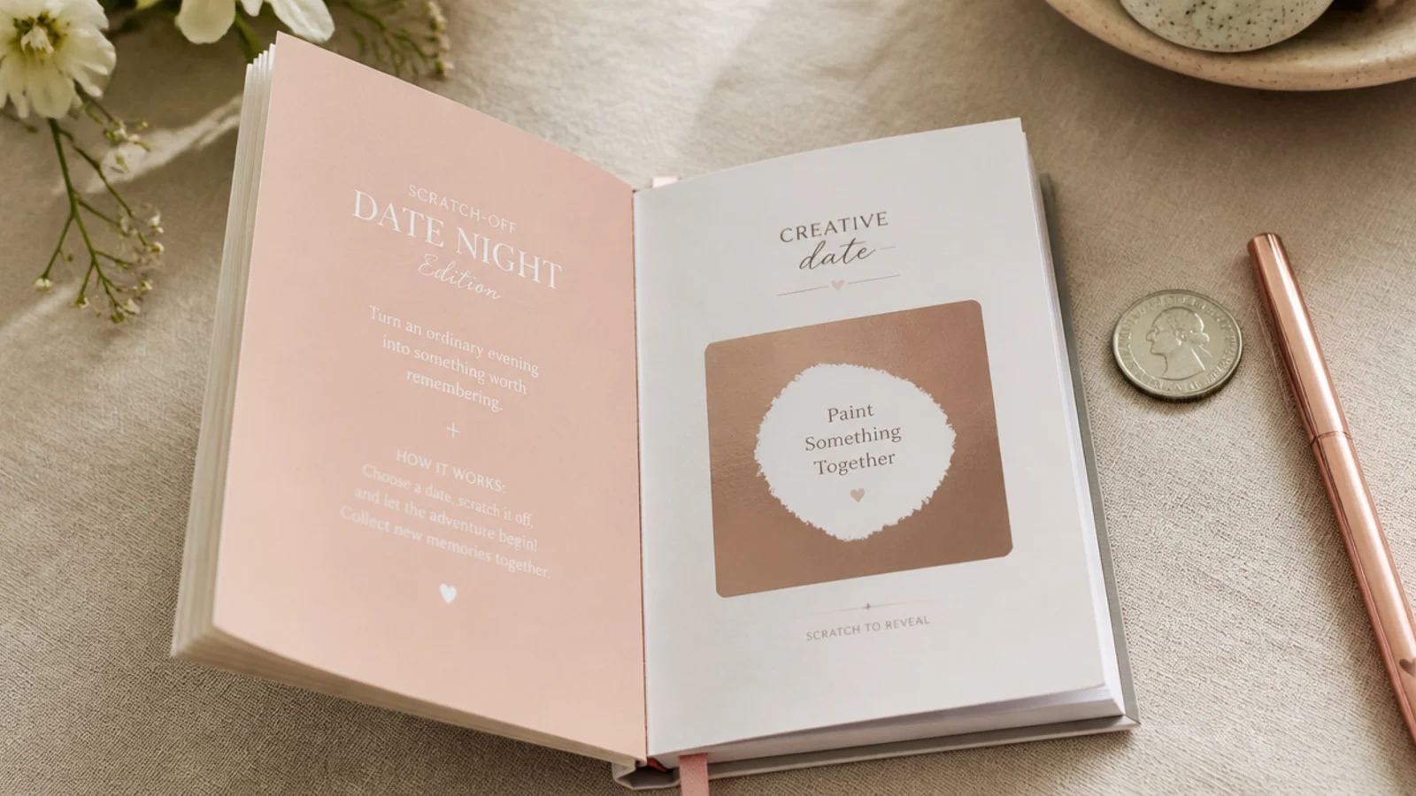 Open scratch-off date-night book with foil panels, a coin and a pen on a linen tabletop