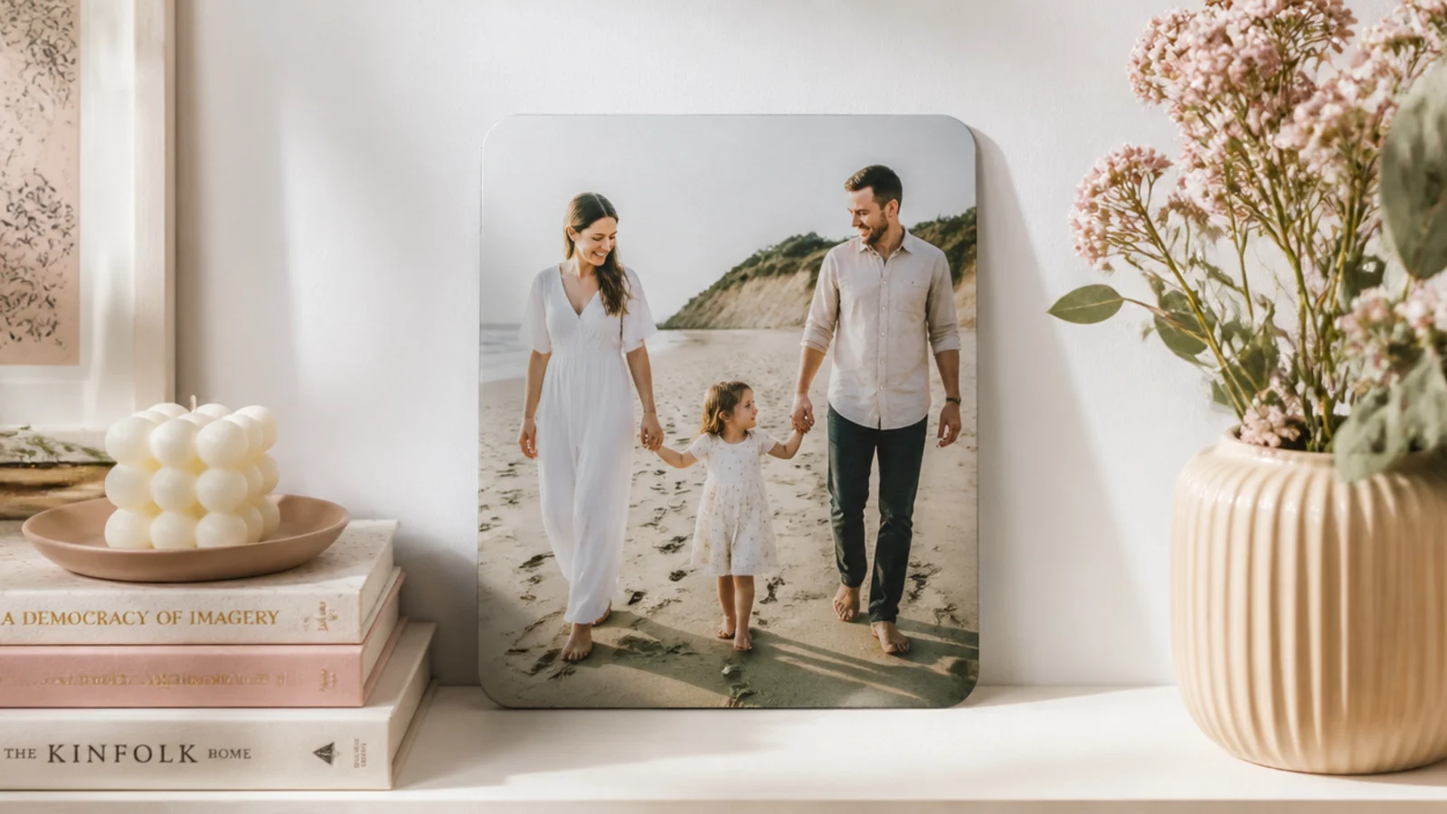 Metal photo print with a soft matte finish leaning against a white wall on a shelf