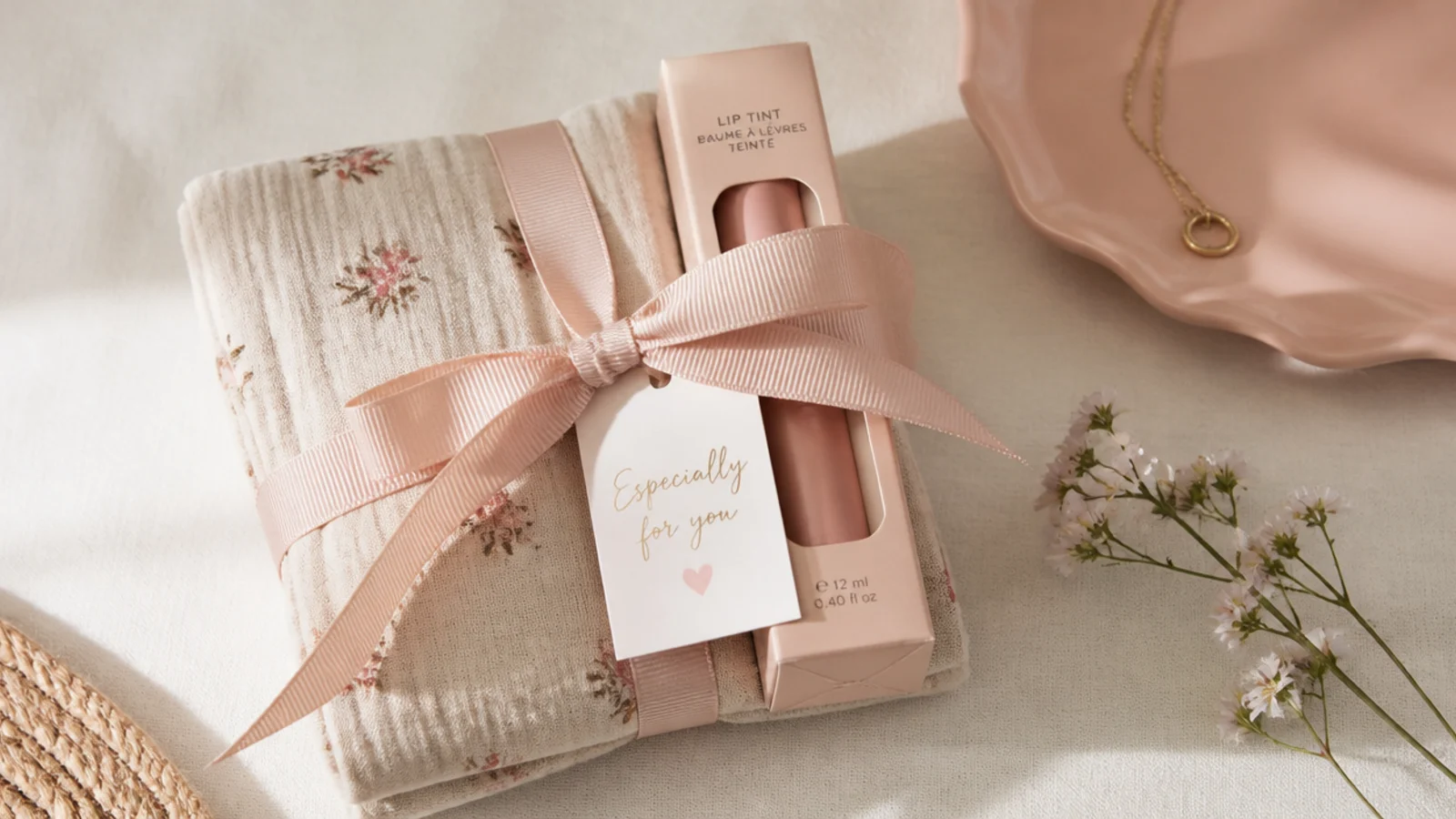 Faceless flat-lay of two small gifts bundled together with ribbon into one set