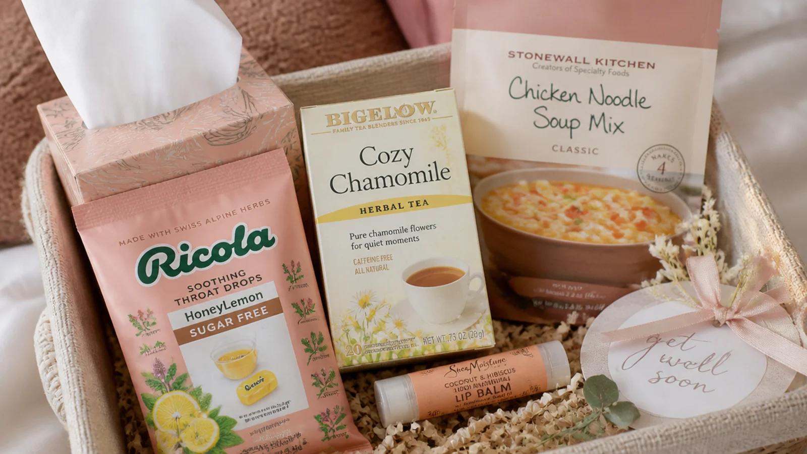 Faceless flat-lay of a get well basket with tissues, throat drops, tea, soup mix and lip balm