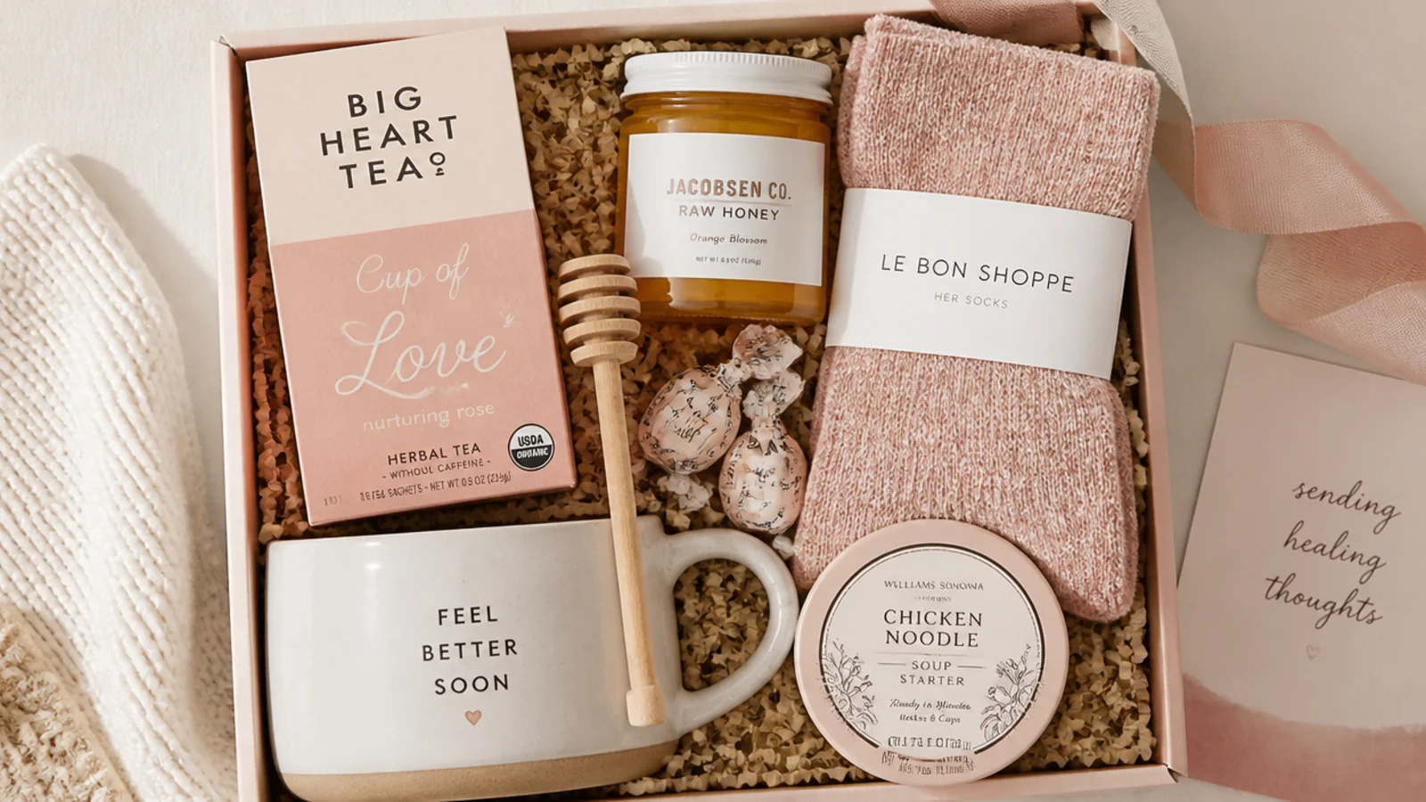 Faceless overhead shot of a get-well care gift hamper with honey lemon tea, soup mug and cozy socks
