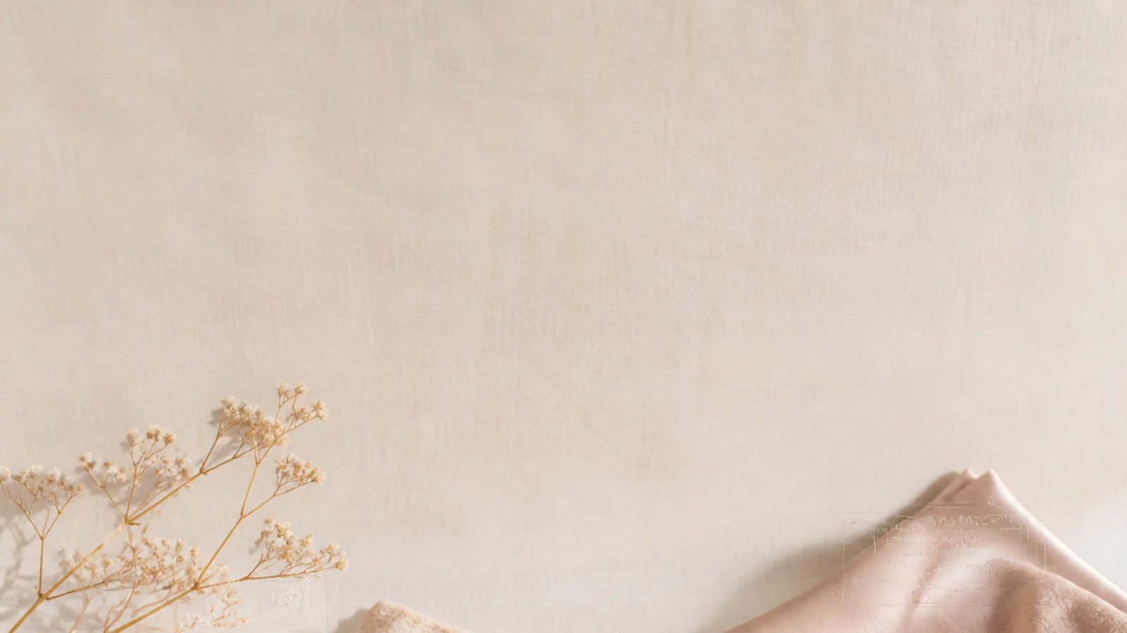 Faceless flat-lay of gift ideas for her with a wrapped box, a silk pillowcase and a candle on a linen background