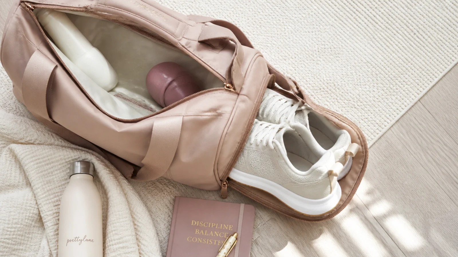 Faceless flat lay of a structured gym duffel with a shoe compartment and a wet pocket open