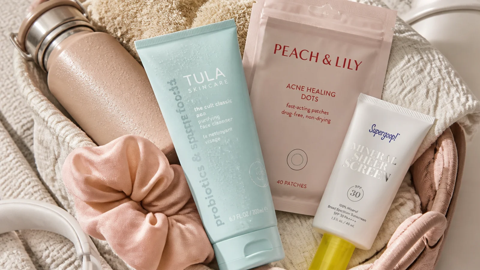 Faceless flat lay of a post-workout skincare basket with a gel cleanser, pimple patches and mineral SPF
