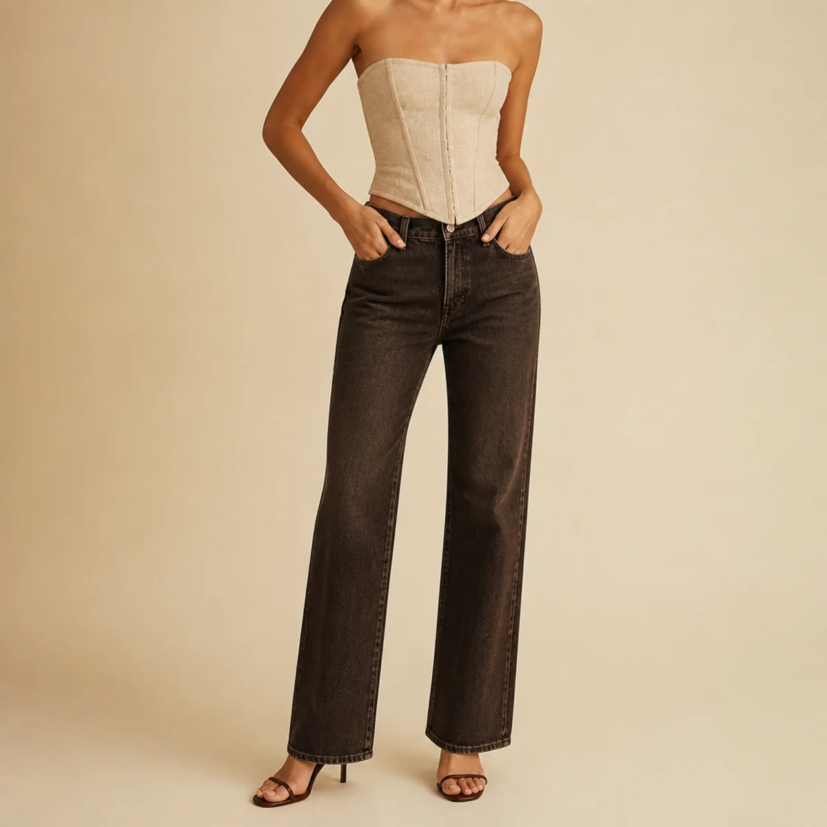 Faceless waist-up shot of a corset top with dark jeans and strappy heels for going out
