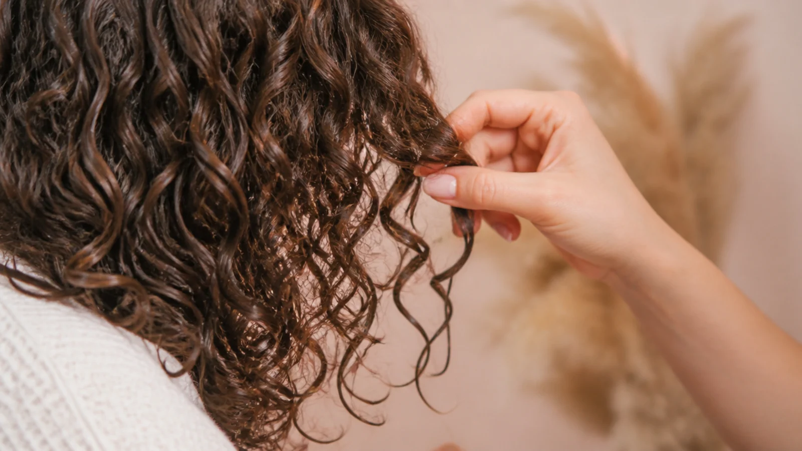 Gel cast curls being scrunched out to reveal soft defined frizz free spirals with shine