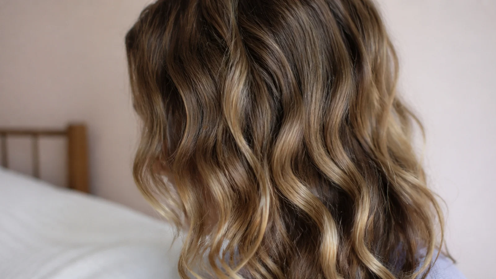 Overnight plopped waves on frizzy wavy hair showing defined S waves with soft volume at the roots