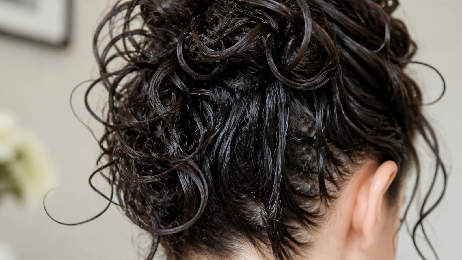 Styling gel scrunched upward into wet frizzy hair to form a sealing cast against humidity