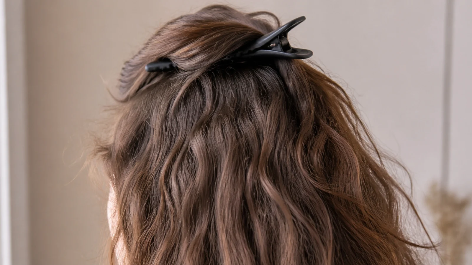 Toothless duckbill clips lifting the roots at the crown of frizzy hair while it air dries