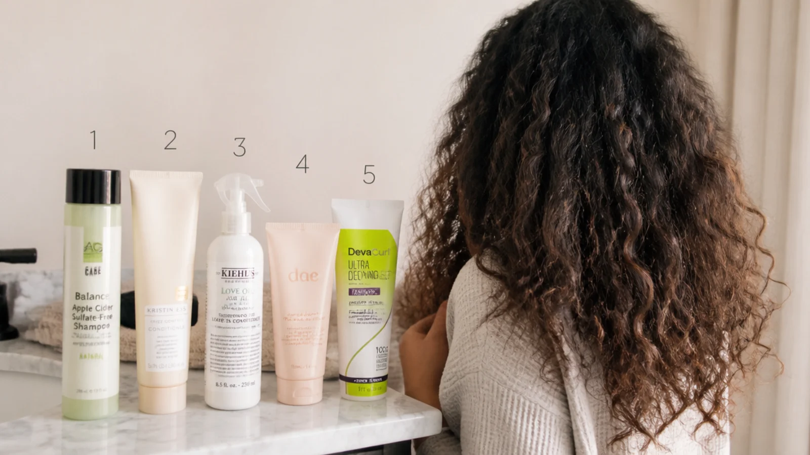Shampoo, conditioner, leave-in, cream and gel lined up in order for a frizzy hair wash day