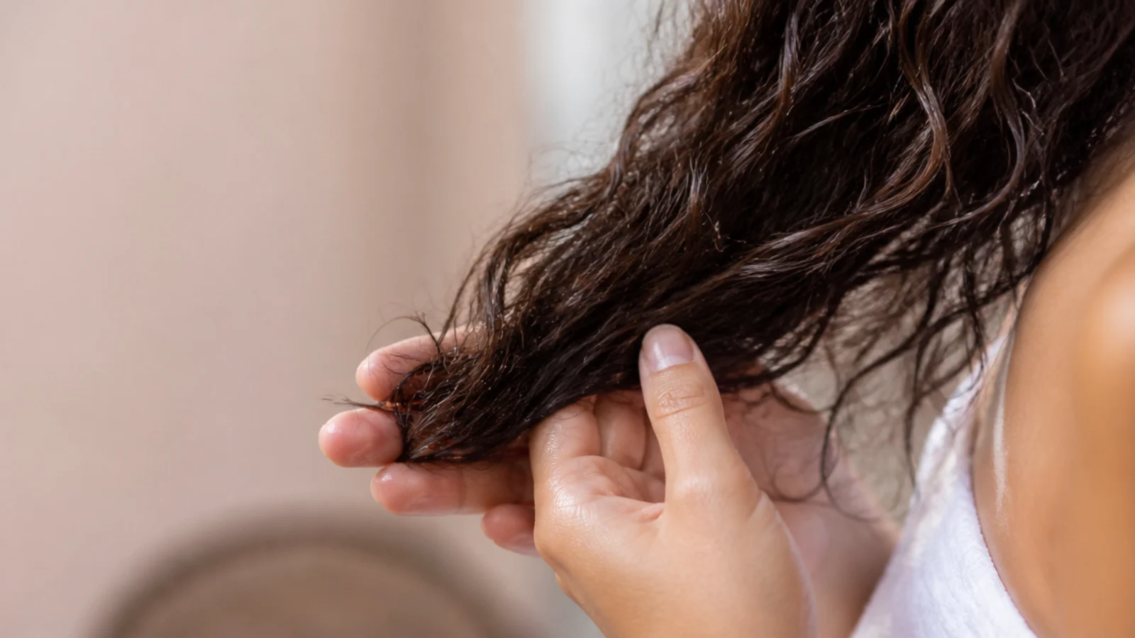 Two drops of argan oil warmed between palms and smoothed onto the damp ends of frizzy hair