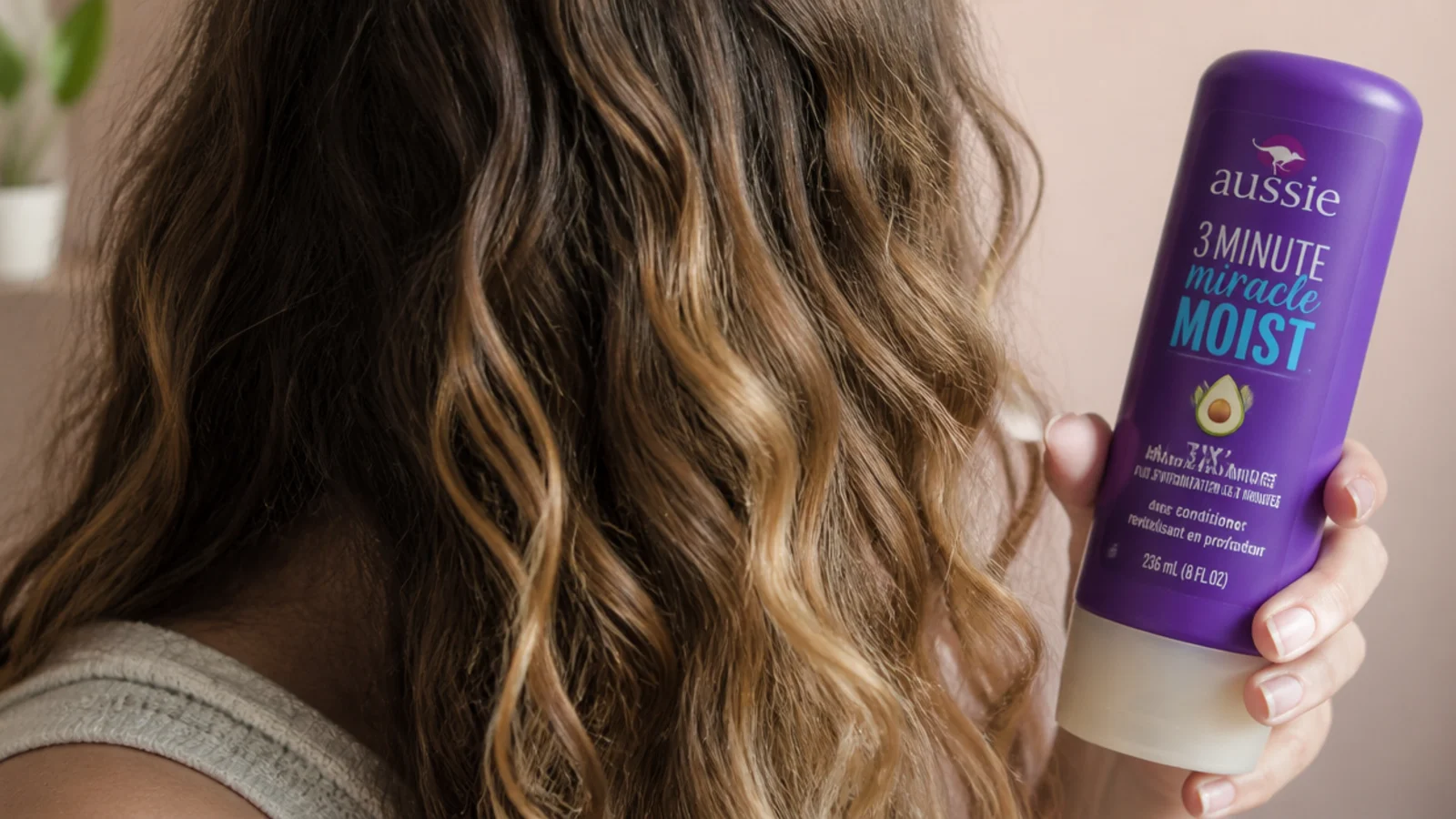 Aussie 3 Minute Miracle Moist deep conditioner bottle used as a weekly hair mask for frizzy hair