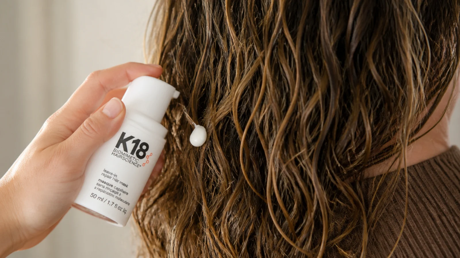 K18 leave-in molecular repair hair mask pumped onto damp damaged frizzy hair