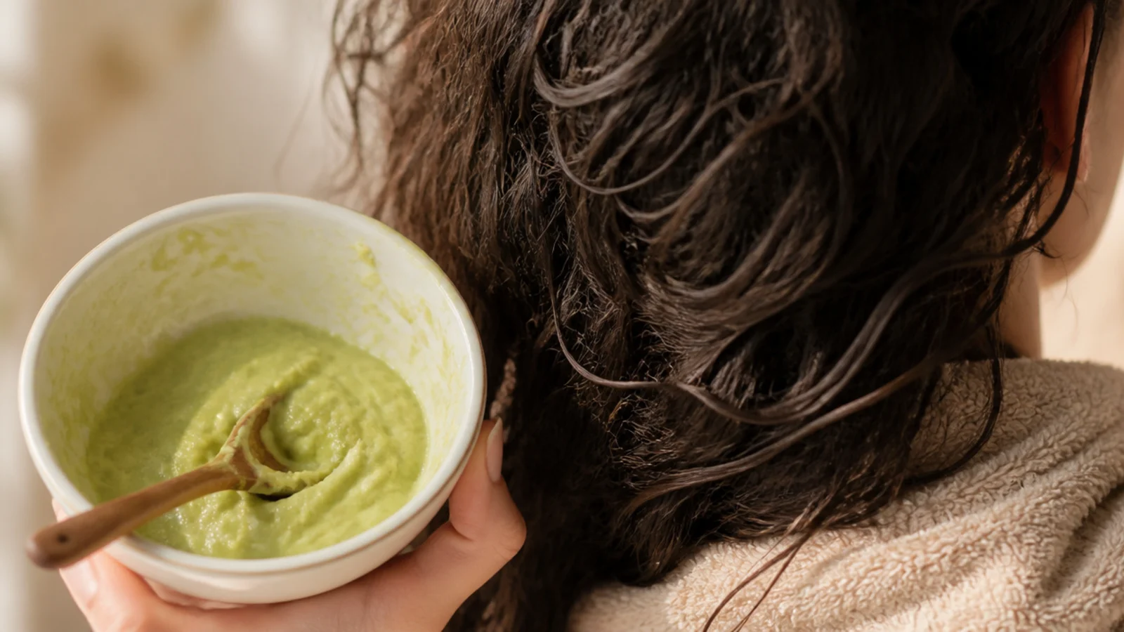 Homemade avocado and coconut oil hair mask blended in a bowl for dry frizzy hair