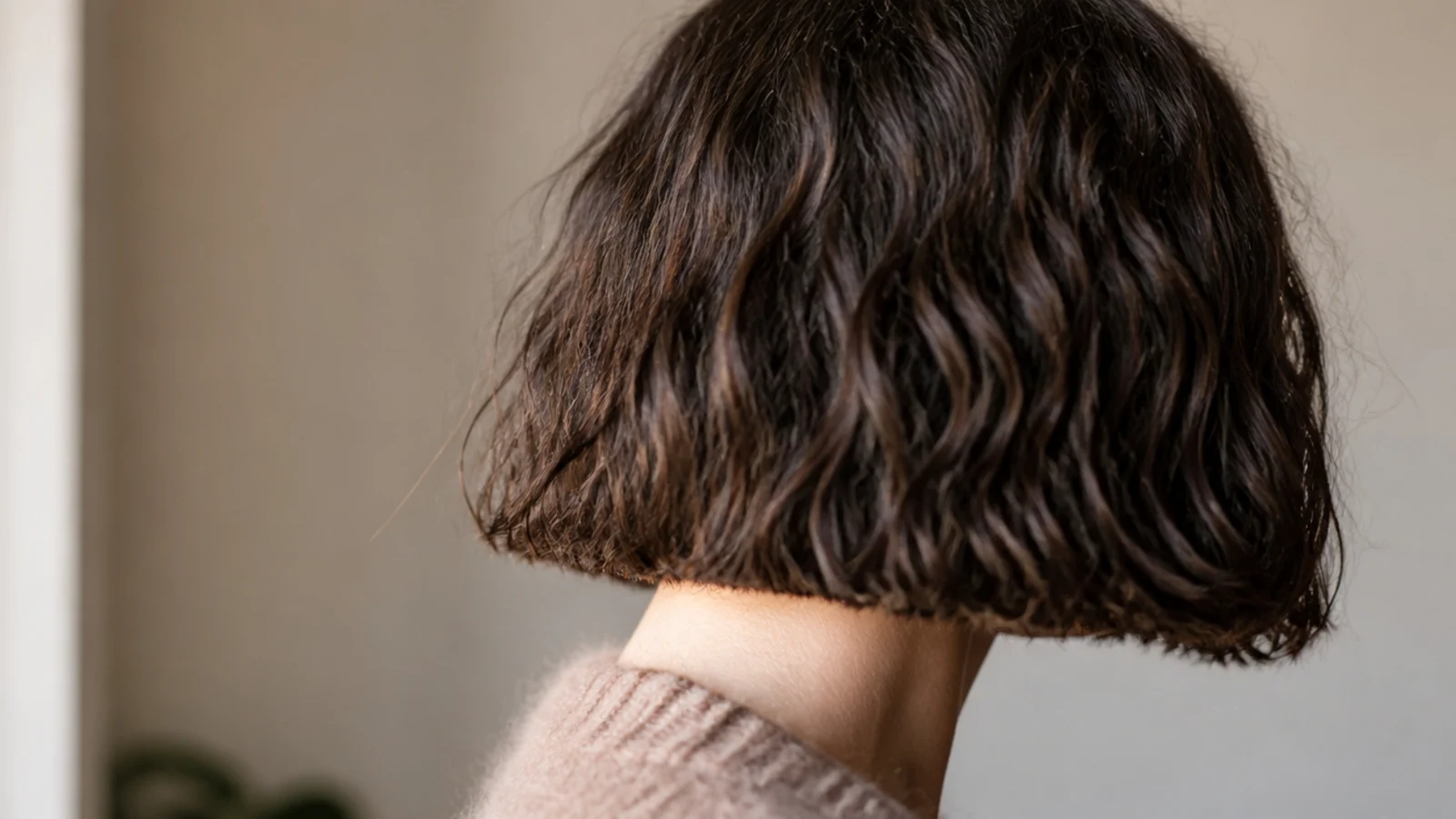 Blunt chin length bob on frizzy hair cut with a heavy perimeter to weigh puffy volume down