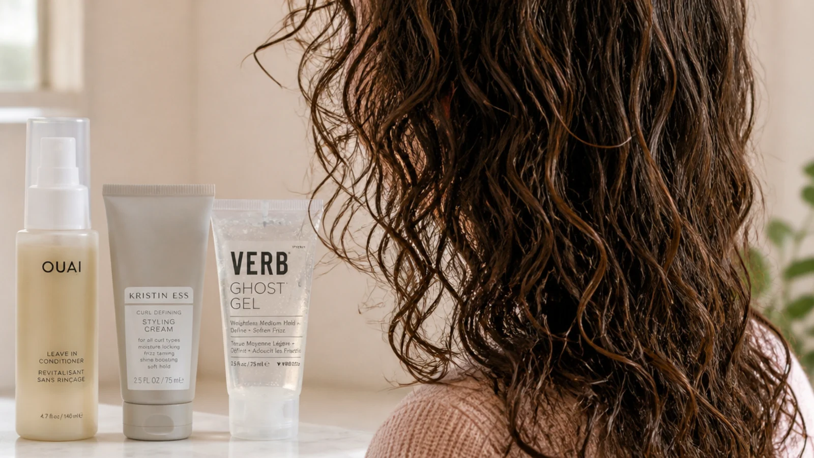 Leave-in conditioner, styling cream and gel lined up in layering order for fixing frizzy hair
