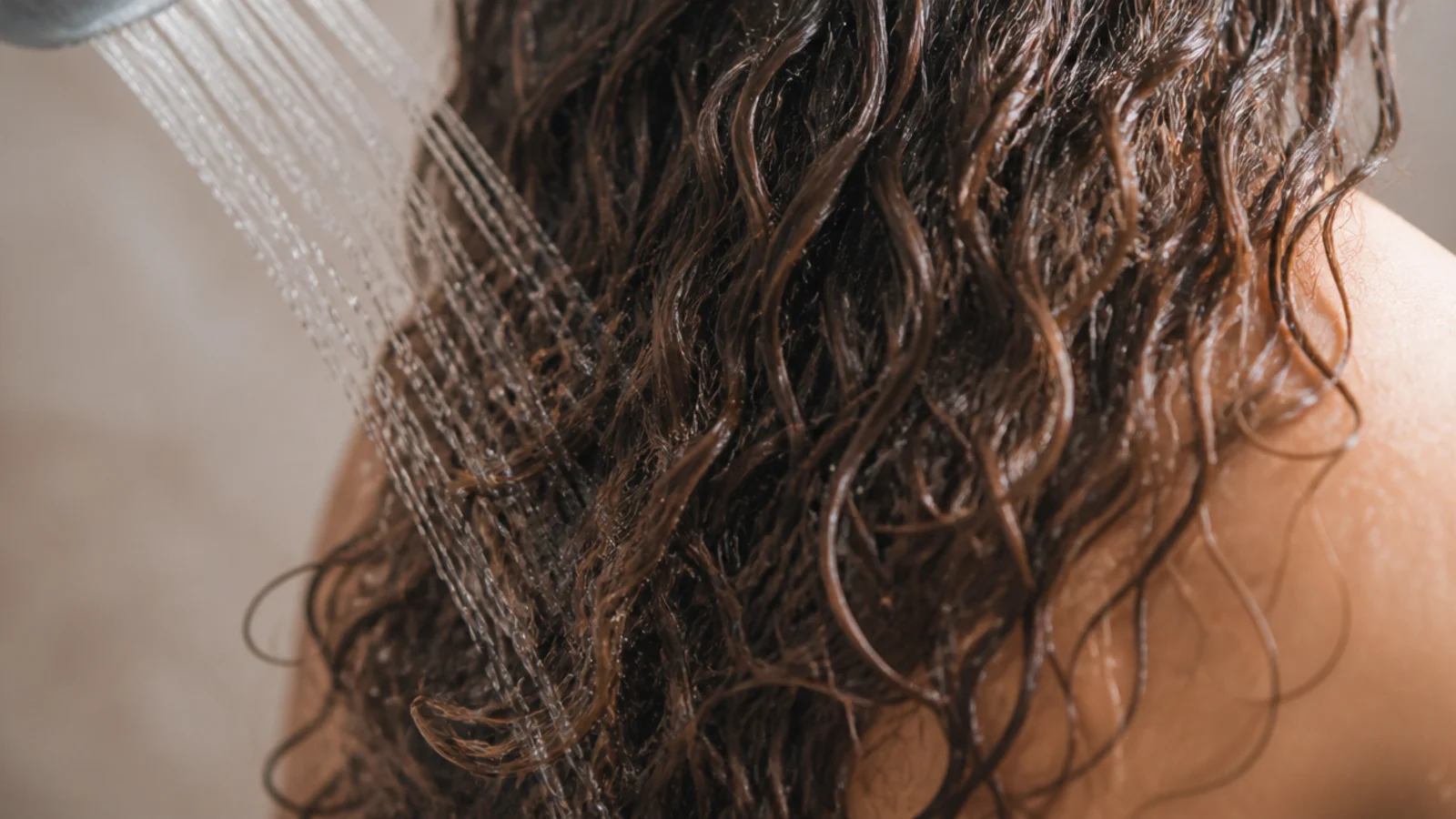 Cold final rinse running over frizzy hair in the shower to close the cuticle and reduce frizz
