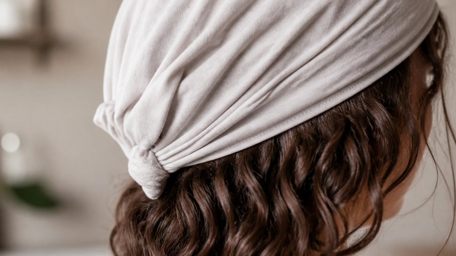 Wavy frizzy hair plopped into a cotton t-shirt on the head to set waves and reduce frizz