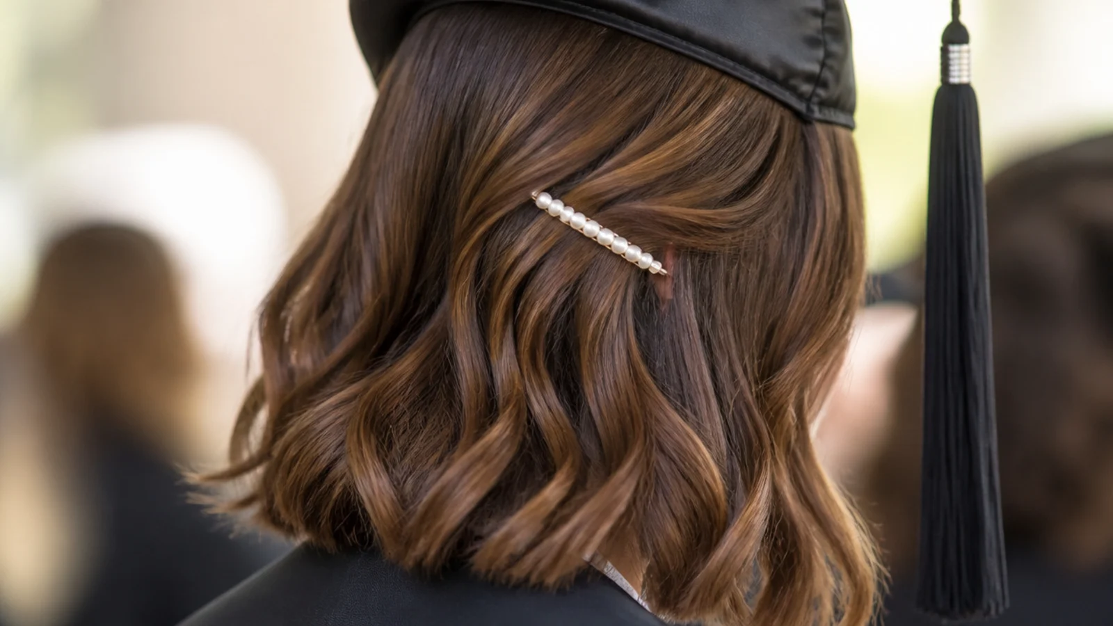 Pearl barrette pin back on a lob graduation hairstyle holding one side behind the ear