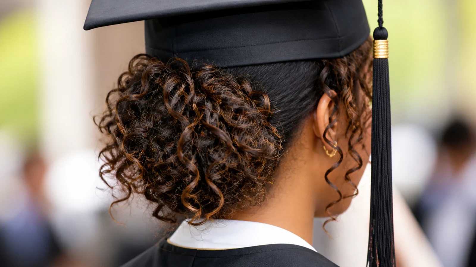 Pinned curly graduation updo on type 3B curls gathered loosely at the nape with visible curl definition
