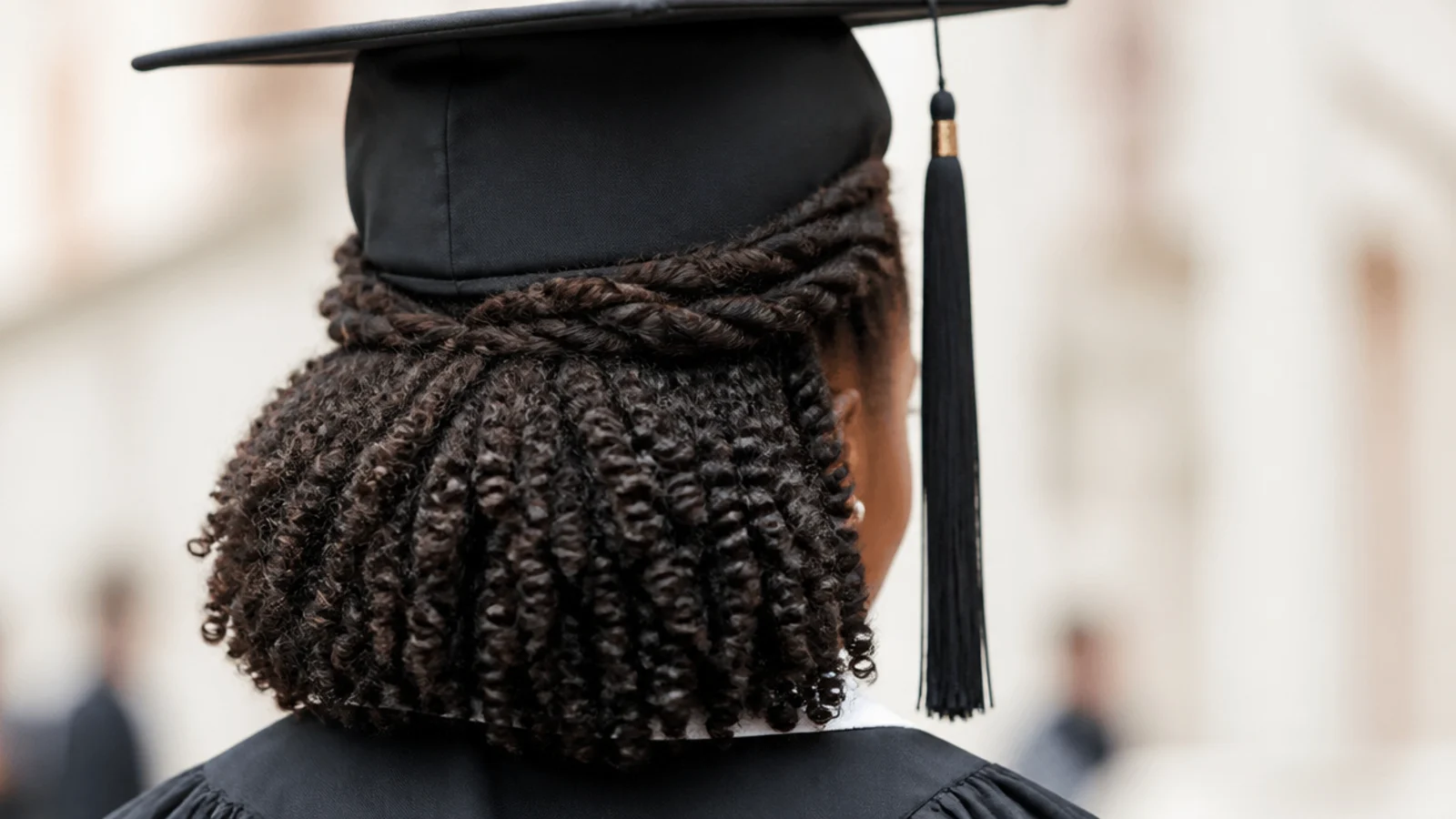 Two strand twist half up graduation hairstyle on 4C hair with twists gathered low and a loose twist-out below