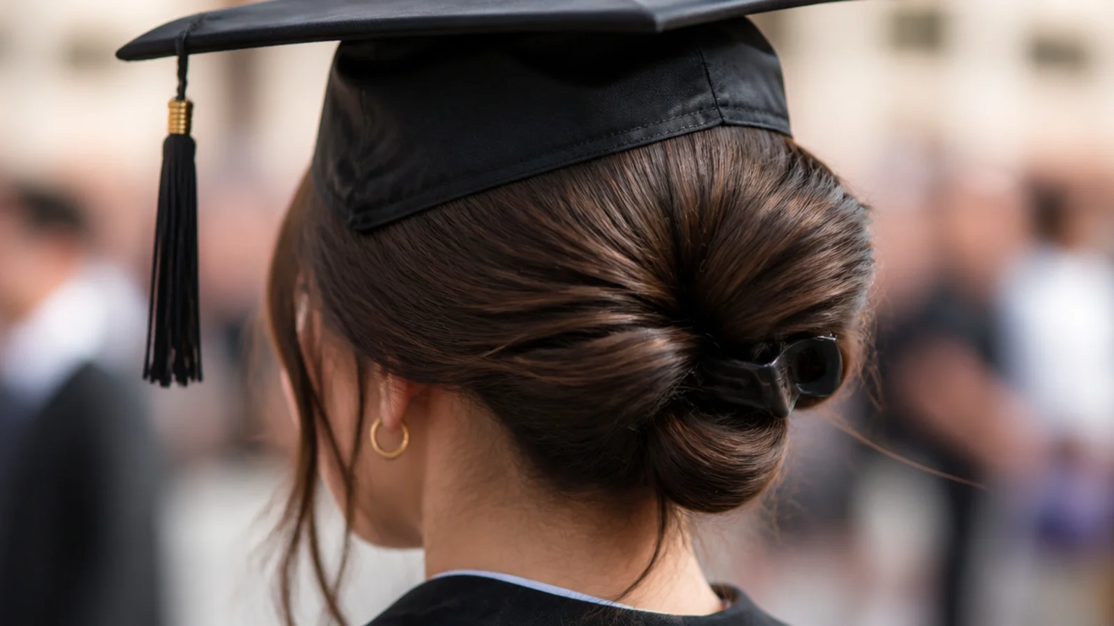 Sleek low claw clip twist graduation hairstyle with a glossy crown and hair twisted into a matte clip