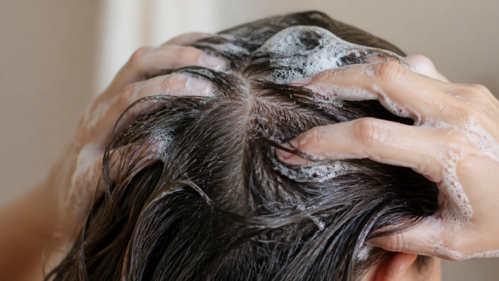 Clarifying shampoo lathered at the roots to remove silicone and dry shampoo buildup