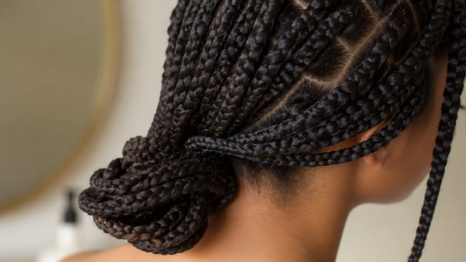Neat chunky box braids gathered loosely at the nape with no tension at the hairline
