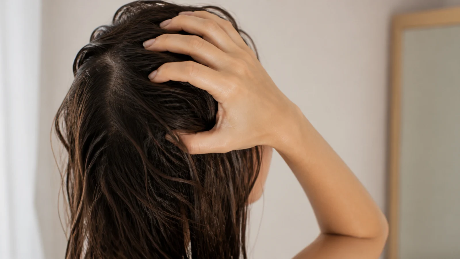 Damp hair being separated with fingers instead of a paddle brush after washing