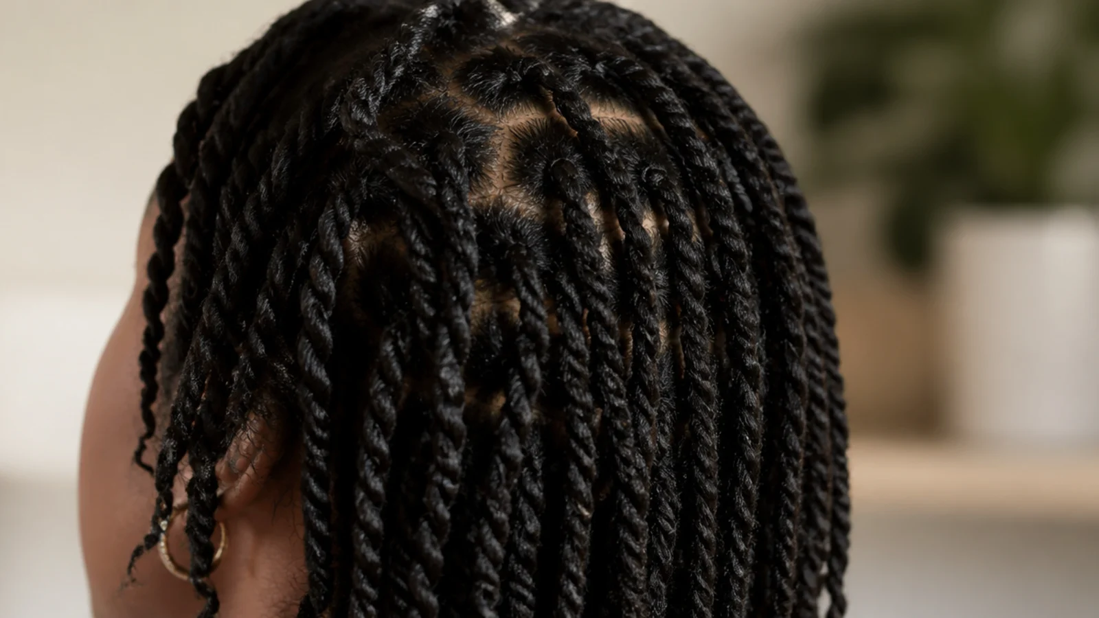 Loose two strand twists in natural hair worn as a low tension protective style