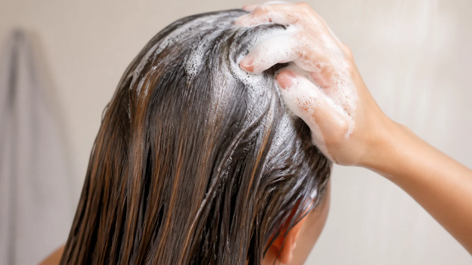 Shampoo lathered only at the roots and scalp while the lengths of the hair hang clean below
